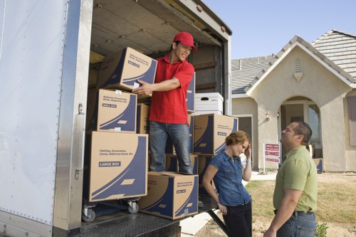 Professional removals team loading boxes into a van