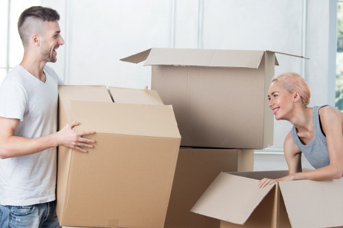 Professional movers handling household items in West Kensington