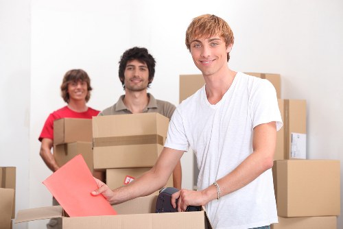 A small team handling boxes and household items during a flat move