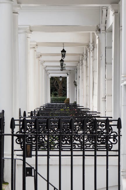 An exterior view of a multi-storey Victorian terrace building in West Kensington, featuring red brick facades with white stone accents and decorative elements. The building has several balconies with